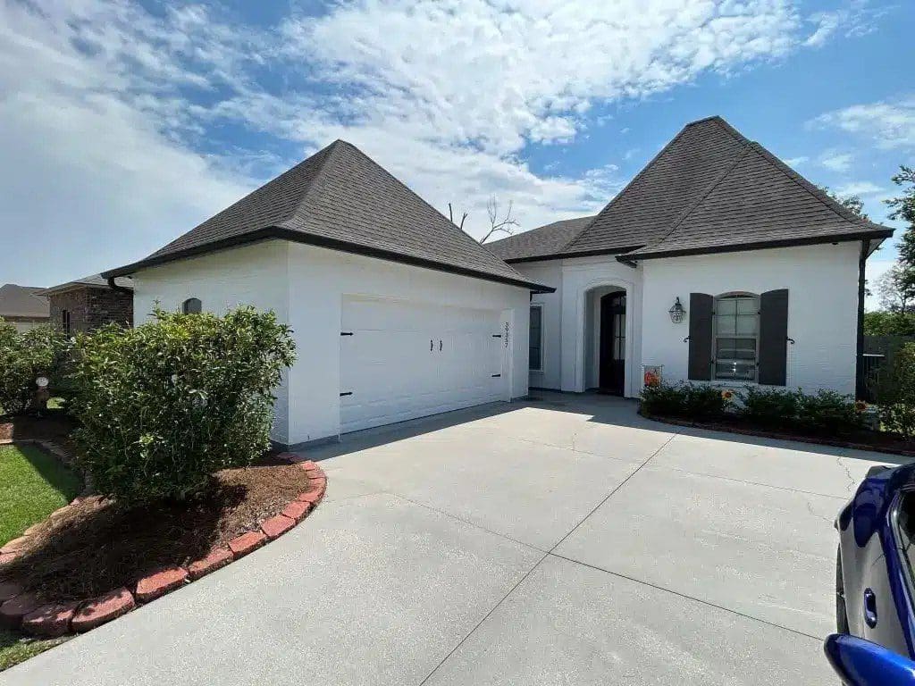 Modern house with a double garage and a clean driveway.