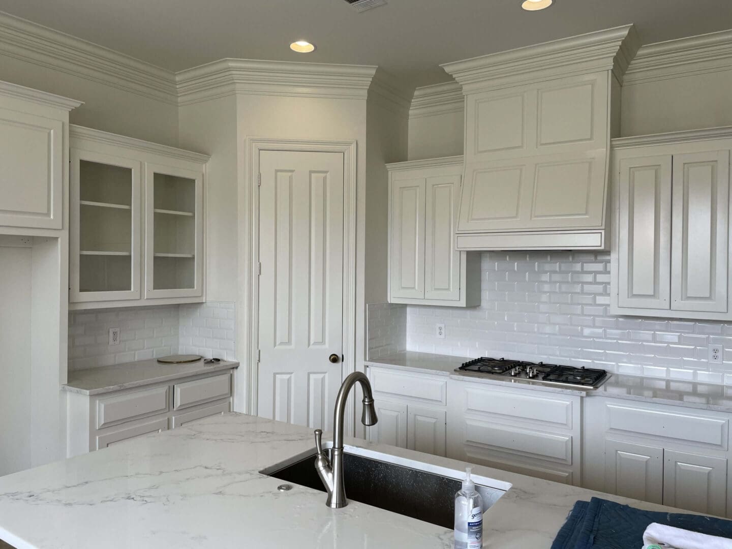 Modern kitchen with white cabinets and island.